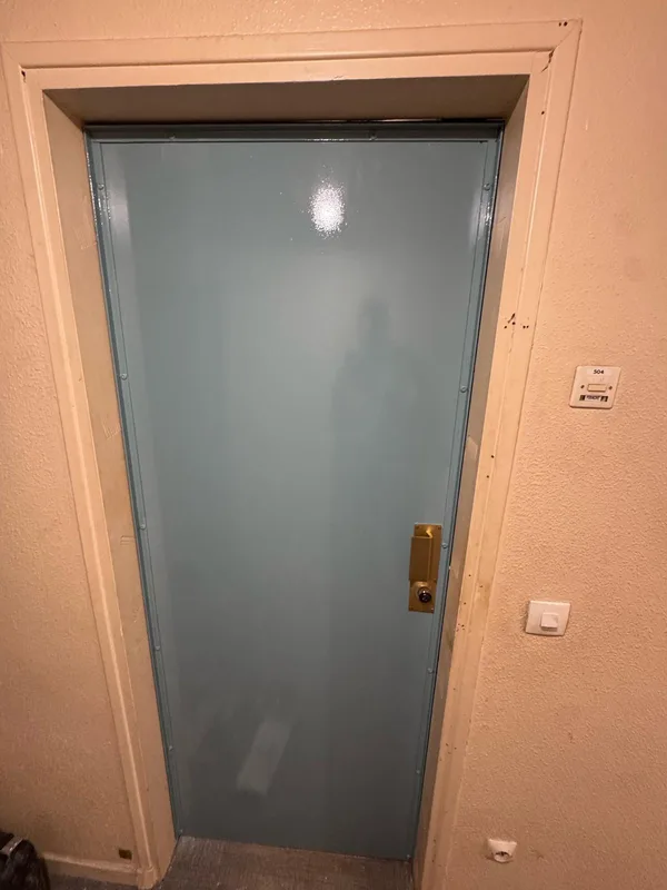Porte d'appartement blindée bleue avec serrure en applique